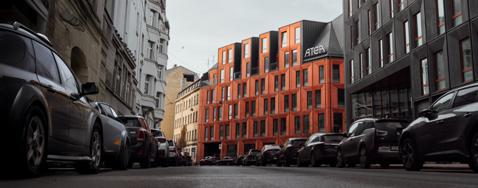 Atea office building with a modern red exterior, viewed from the street.
